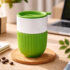 горнятко керамічне Barell ТМ Discover з зеленою силіконовою накладкою та кришкою на столі