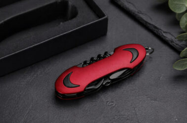 ніж Flint TM Discover багатофункціональний червоний у закритому вигляді на темному фоні